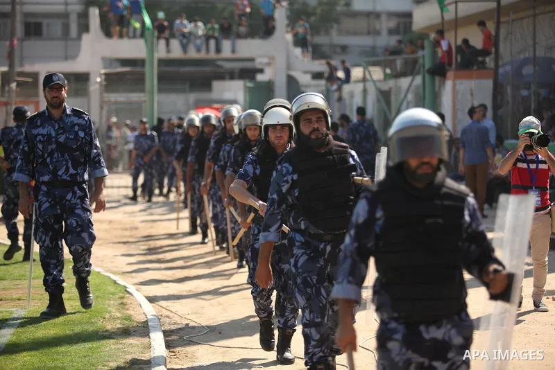 Palestinian policemen take position during the first leg match of the Palestine Cup final between Hebron's Al-Ahly team and Gaza's Shejaya team at Yarmuk stadium in Gaza City, on August 6, 2015, as the two teams play eac...