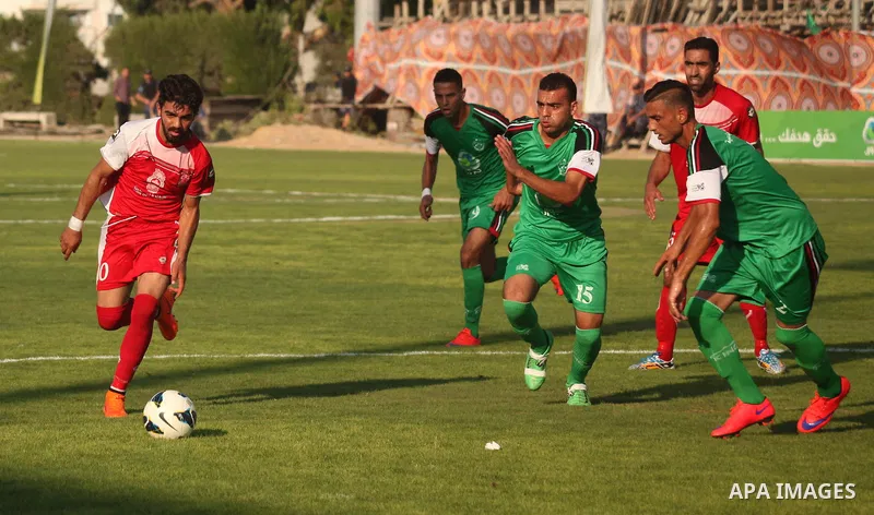 Palestinian Gaza's Shejaya players and Hebron's Al-Ahly players compete during the first leg match of the Palestine Cup final at Yarmuk stadium in Gaza City, on August 6, 2015, as the two teams play each other for the fi...