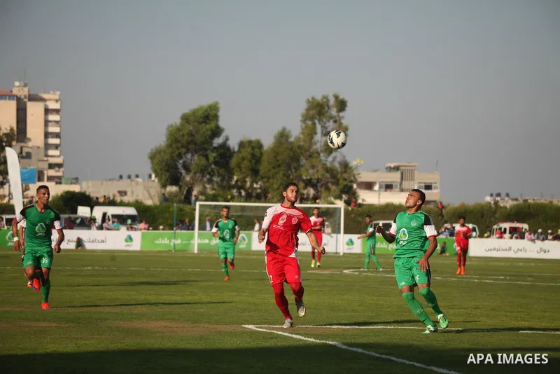 Palestinian Gaza's Shejaya players and Hebron's Al-Ahly players compete during the first leg match of the Palestine Cup final at Yarmuk stadium in Gaza City, on August 6, 2015, as the two teams play each other for the fi...