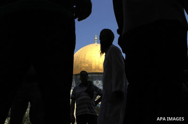 Palestinian worshipers walk outside the Dome of the Rock after Friday prayers at the Al-Aqsa mosque compound, Islam's third holiest site which is also sacred to the Jews and known to them as Temple Mount, in the Old City...