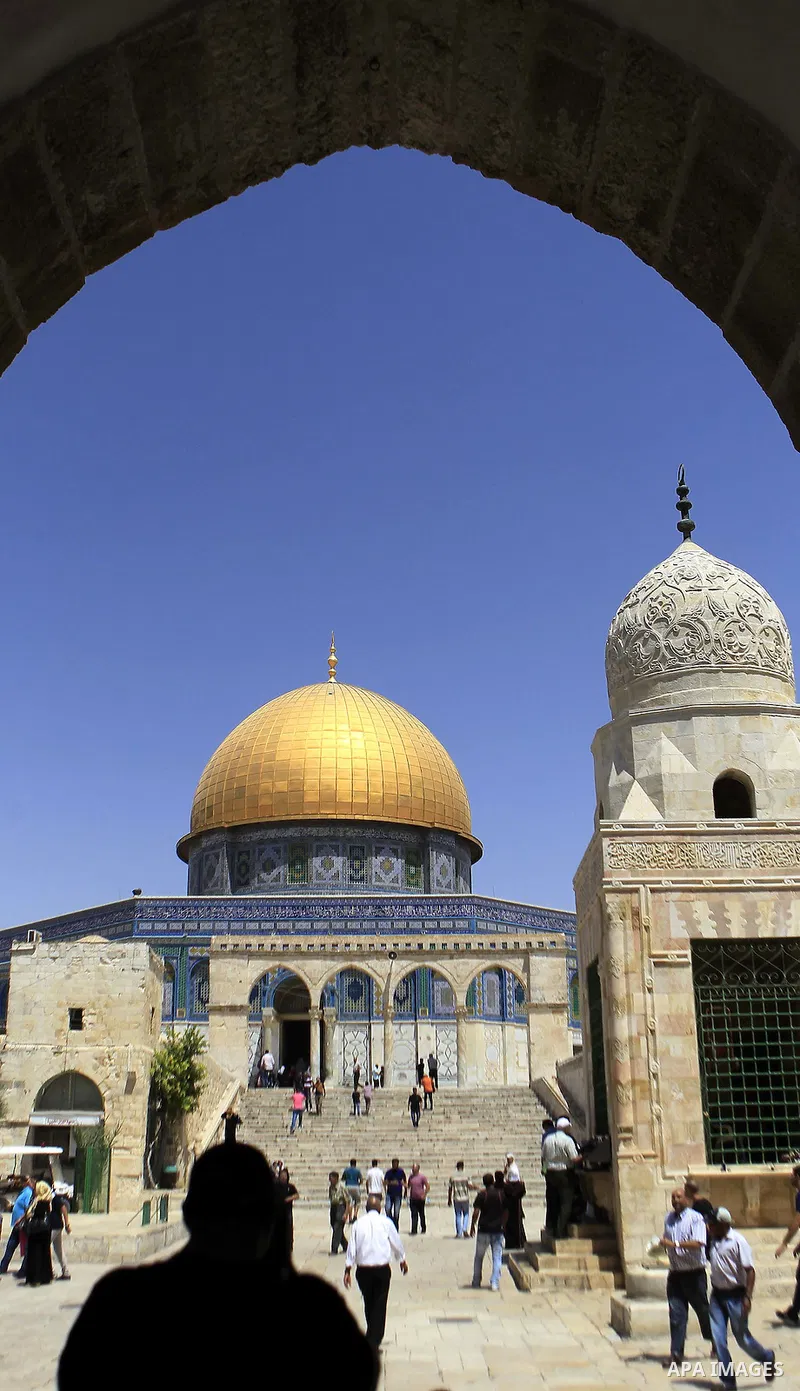 Palestinian worshipers walk outside the Dome of the Rock after Friday prayers at the Al-Aqsa mosque compound, Islam's third holiest site which is also sacred to the Jews and known to them as Temple Mount, in the Old City...