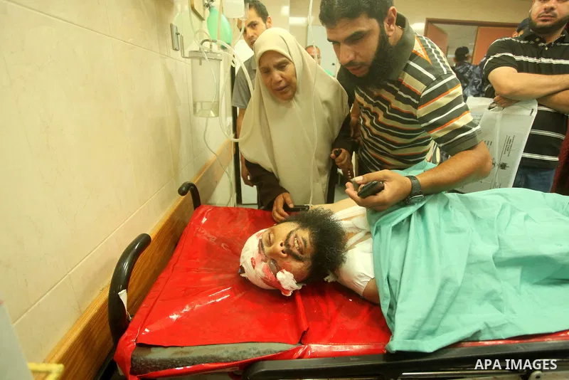 A wounded Palestinian is brought into a hospital following what witnesses said was an Israeli air strike in the central Gaza Strip August 7, 2015. An Israeli plane attacked an armed training camp of the Islamist Hamas gr...