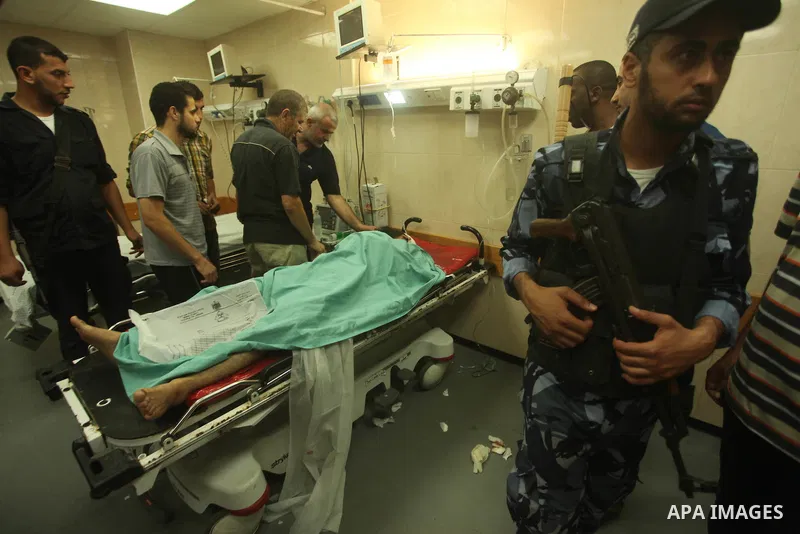 A wounded Palestinian is brought into a hospital following what witnesses said was an Israeli air strike in the central Gaza Strip August 7, 2015. An Israeli plane attacked an armed training camp of the Islamist Hamas gr...