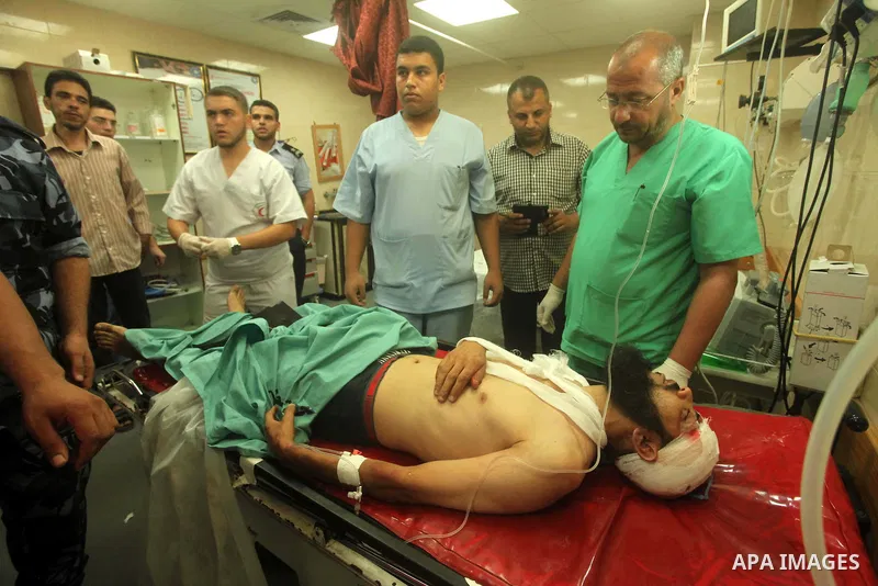 A wounded Palestinian is brought into a hospital following what witnesses said was an Israeli air strike in the central Gaza Strip August 7, 2015. An Israeli plane attacked an armed training camp of the Islamist Hamas gr...