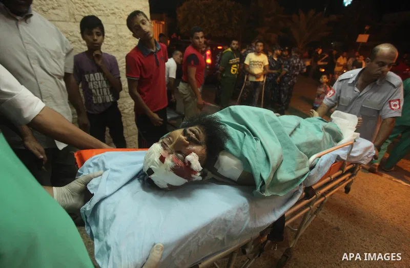 A wounded Palestinian is brought into a hospital following what witnesses said was an Israeli air strike in the central Gaza Strip August 7, 2015. An Israeli plane attacked an armed training camp of the Islamist Hamas gr...