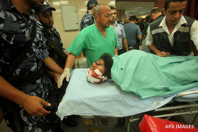 A wounded Palestinian is brought into a hospital following what witnesses said was an Israeli air strike in the central Gaza Strip August 7, 2015. An Israeli plane attacked an armed training camp of the Islamist Hamas gr...