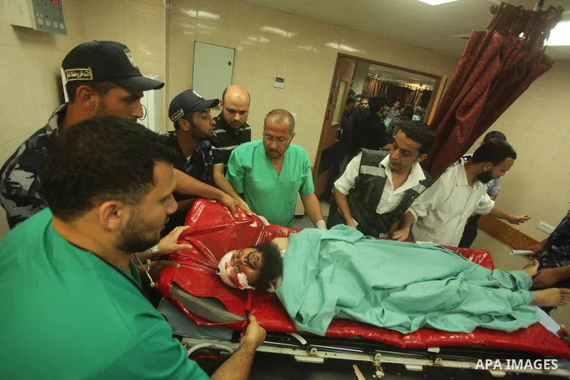 A wounded Palestinian is brought into a hospital following what witnesses said was an Israeli air strike in the central Gaza Strip August 7, 2015. An Israeli plane attacked an armed training camp of the Islamist Hamas gr...