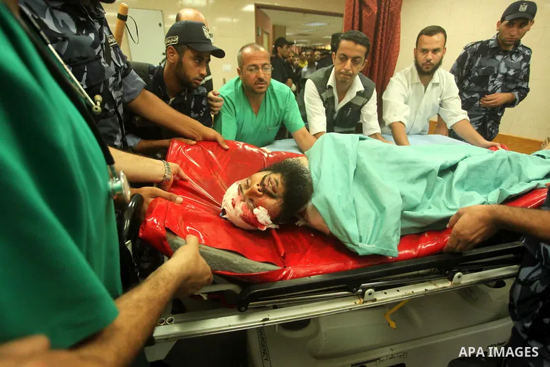 A wounded Palestinian is brought into a hospital following what witnesses said was an Israeli air strike in the central Gaza Strip August 7, 2015. An Israeli plane attacked an armed training camp of the Islamist Hamas gr...