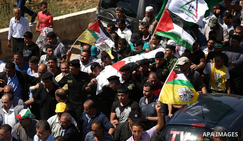 Palestinian mourners carry the body of Saad Dawabsha, the father of a Palestinian toddler killed last week when their home was firebombed by Jewish extremists, during his funeral in the West Bank village of Duma on Augus...