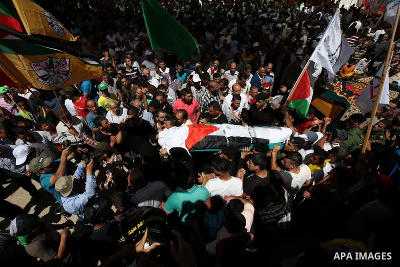 Palestinian mourners carry the body of Saad Dawabsha, the father of a Palestinian toddler killed last week when their home was firebombed by Jewish extremists, during his funeral in the West Bank village of Duma on Augus...