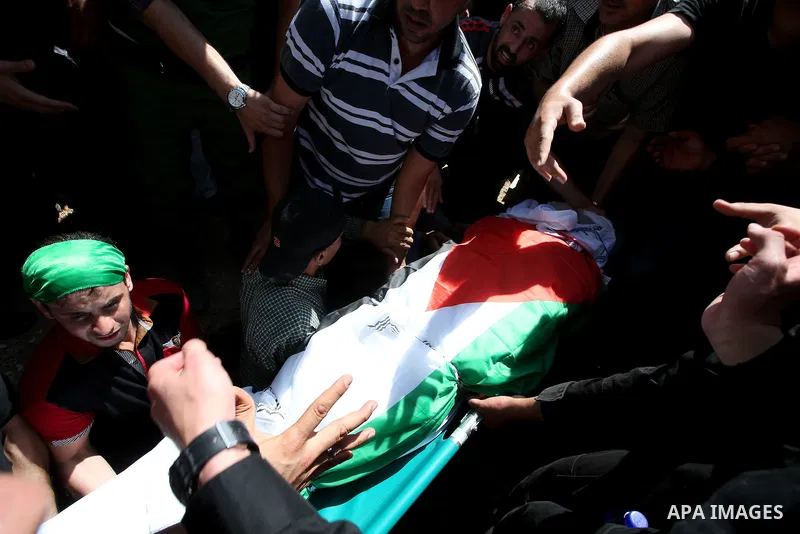 Palestinian mourners carry the body of Saad Dawabsha, the father of a Palestinian toddler killed last week when their home was firebombed by Jewish extremists, during his funeral in the West Bank village of Duma on Augus...
