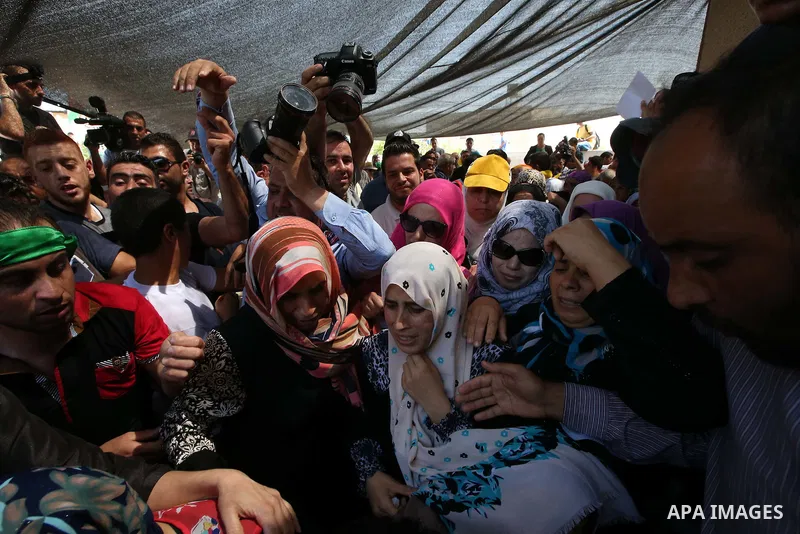 Relatives mourn during the funeral of Saad Dawabsha, the father of a Palestinian toddler killed last week when their home was firebombed by Jewish extremists, in the West Bank village of Duma on August 8, 2015. Dawabsha...