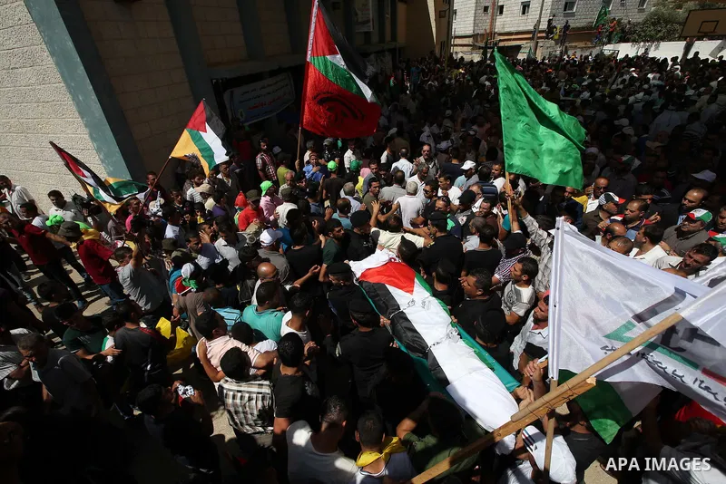 Palestinian mourners carry the body of Saad Dawabsha, the father of a Palestinian toddler killed last week when their home was firebombed by Jewish extremists, during his funeral in the West Bank village of Duma on Augus...