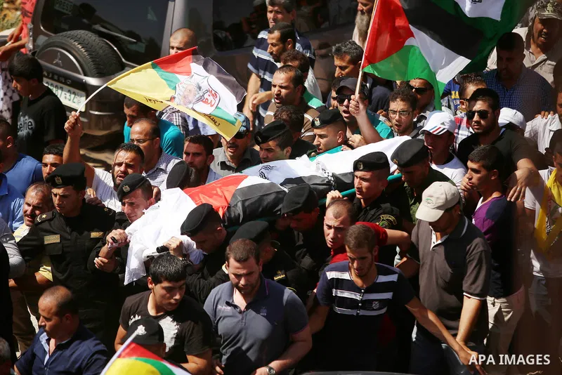 Palestinian mourners carry the body of Saad Dawabsha, the father of a Palestinian toddler killed last week when their home was firebombed by Jewish extremists, during his funeral in the West Bank village of Duma on Augus...
