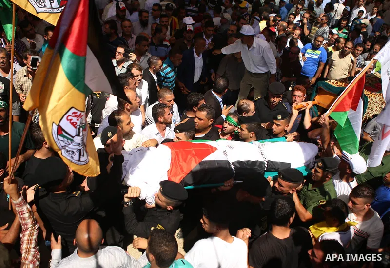 Palestinian mourners carry the body of Saad Dawabsha, the father of a Palestinian toddler killed last week when their home was firebombed by Jewish extremists, during his funeral in the West Bank village of Duma on Augus...