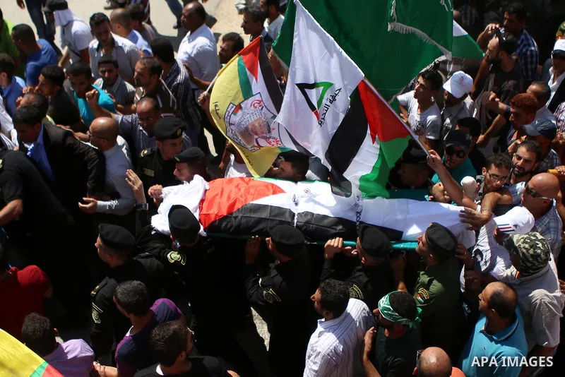 Palestinian mourners carry the body of Saad Dawabsha, the father of a Palestinian toddler killed last week when their home was firebombed by Jewish extremists, during his funeral in the West Bank village of Duma on Augus...