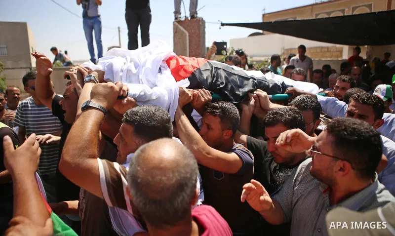 Palestinian mourners carry the body of Saad Dawabsha, the father of a Palestinian toddler killed last week when their home was firebombed by Jewish extremists, during his funeral in the West Bank village of Duma on Augus...