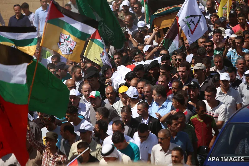 Palestinian mourners carry the body of Saad Dawabsha, the father of a Palestinian toddler killed last week when their home was firebombed by Jewish extremists, during his funeral in the West Bank village of Duma on Augus...
