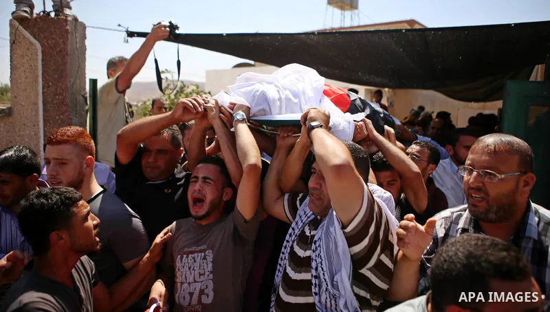 Palestinian mourners carry the body of Saad Dawabsha, the father of a Palestinian toddler killed last week when their home was firebombed by Jewish extremists, during his funeral in the West Bank village of Duma on Augus...