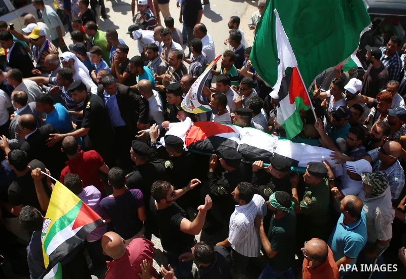Palestinian mourners carry the body of Saad Dawabsha, the father of a Palestinian toddler killed last week when their home was firebombed by Jewish extremists, during his funeral in the West Bank village of Duma on Augus...