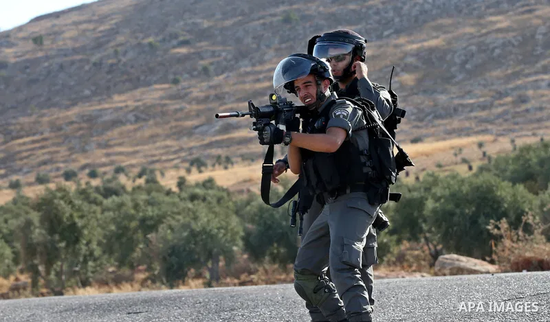 Israeli security forces take position during clashes with Palestinian protesters on a street leading to Duma village, in a demonstration following the funeral of Saad Dawabsha, the father of a Palestinian toddler killed...