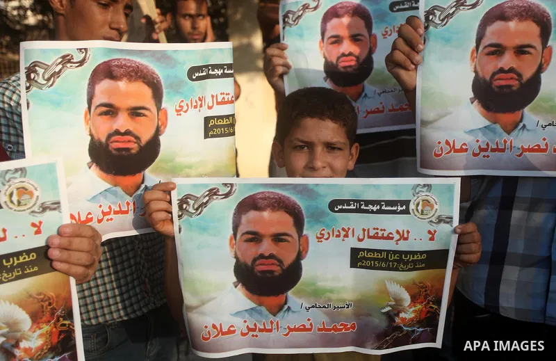 Protesters hold portraits of Palestinian prisoner in Israeli jails Mohammad Allan, during a protest outside United Nations headquarter, in Gaza city on August 8, 2015. The Israeli military prosecutor intends to request c...