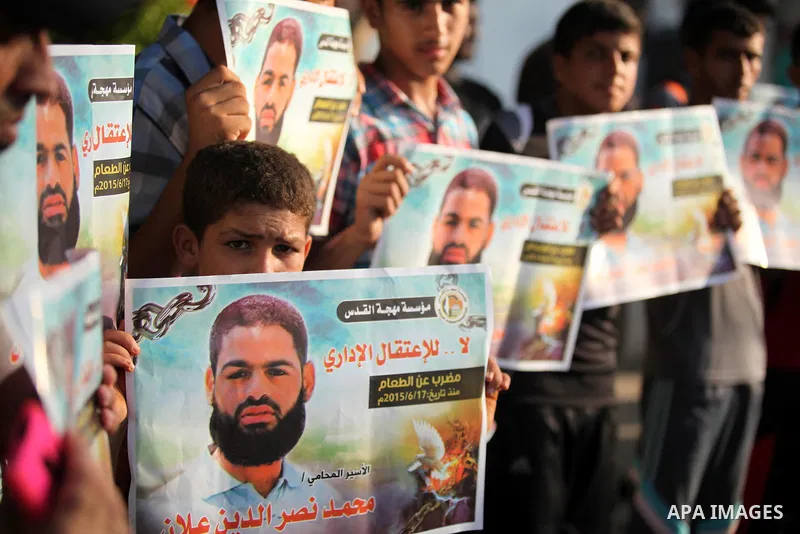 Protesters hold portraits of Palestinian prisoner in Israeli jails Mohammad Allan, during a protest outside United Nations headquarter, in Gaza city on August 8, 2015. The Israeli military prosecutor intends to request c...