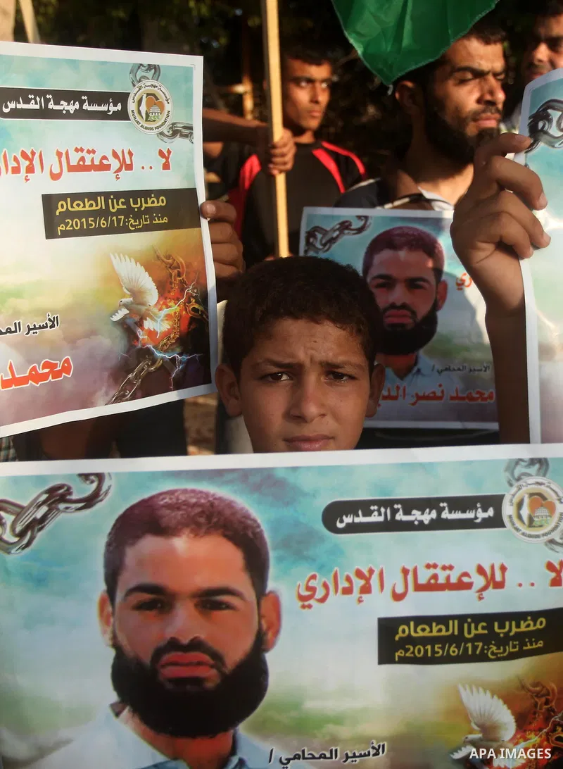 Protesters hold portraits of Palestinian prisoner in Israeli jails Mohammad Allan, during a protest outside United Nations headquarter, in Gaza city on August 8, 2015. The Israeli military prosecutor intends to request c...