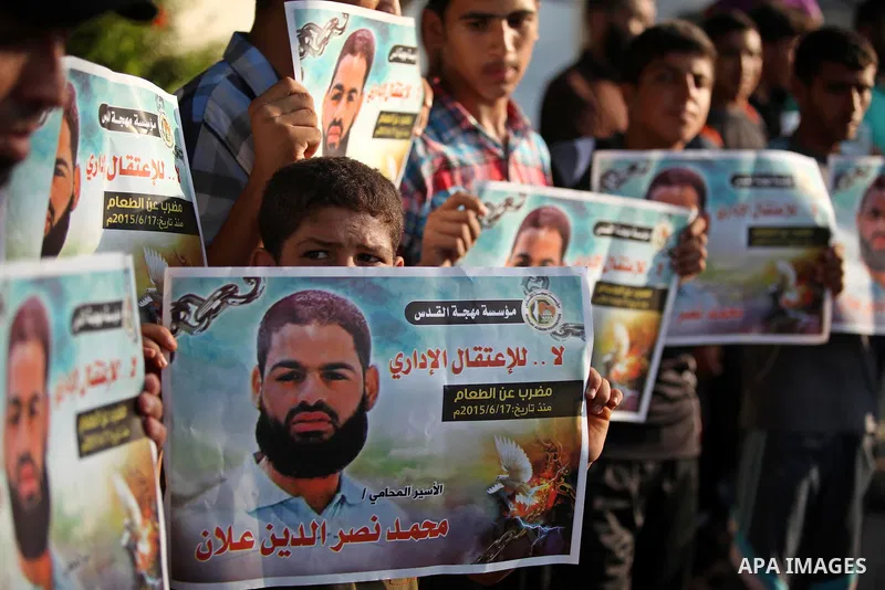 Protesters hold portraits of Palestinian prisoner in Israeli jails Mohammad Allan, during a protest outside United Nations headquarter, in Gaza city on August 8, 2015. The Israeli military prosecutor intends to request c...