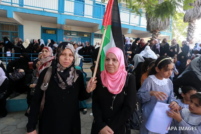 Palestinian Teachers hold banners during a protest against the reduction of educational programs given by United Nations Relief and Works Agency (UNRWA) in Jabalia in the northern of Gaza strip on August 9, 2015. The UNR...