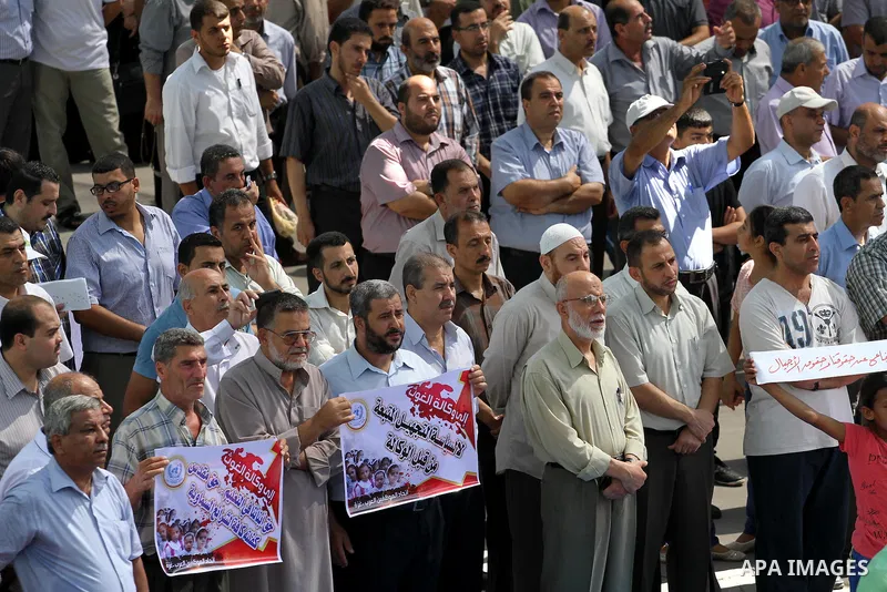Palestinian Teachers hold banners during a protest against the reduction of educational programs given by United Nations Relief and Works Agency (UNRWA) in Jabalia in the northern of Gaza strip on August 9, 2015. The UNR...