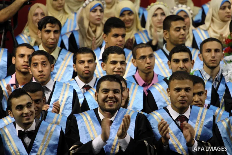 Palestinian students take part in their graduation ceremony at the Islamic University in Gaza city on August 9, 2015. Photo by Mohammed Asad
