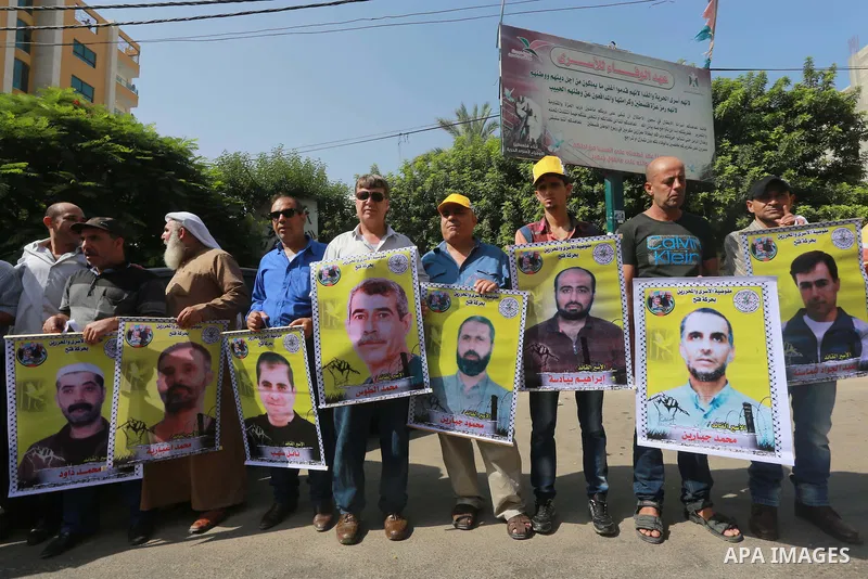 Palestinians take part in a protest demanding release the prisoners in Israeli jails, in front of Red cross office, in Gaza city, on on August 10, 2015. Photo by Mohammed Asad