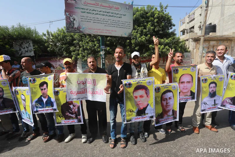Palestinians take part in a protest demanding release the prisoners in Israeli jails, in front of Red cross office, in Gaza city, on on August 10, 2015. Photo by Mohammed Asad
