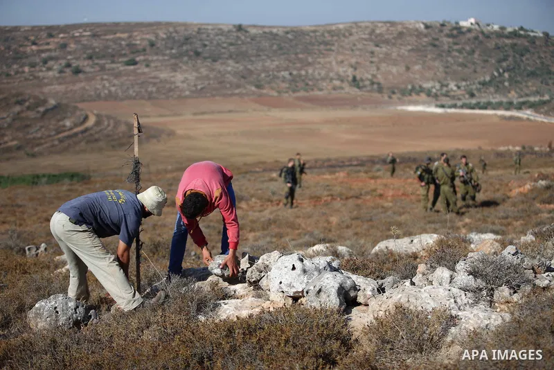 Israeli soldiers stand guard during a military operation on the Palestinian lands in the West Bank village of Qasra southern Nablus on August 10, 2015. Photo by Ahmad Talat