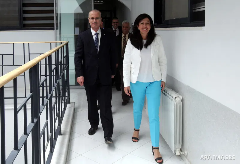 Palestinian Prime Minister Rami Hamdallah meets with the Minister of Minister of Economy Abir Oudeh, in the West Bank city of Ramallah on August 10, 2015. Photo by Prime Minister Office