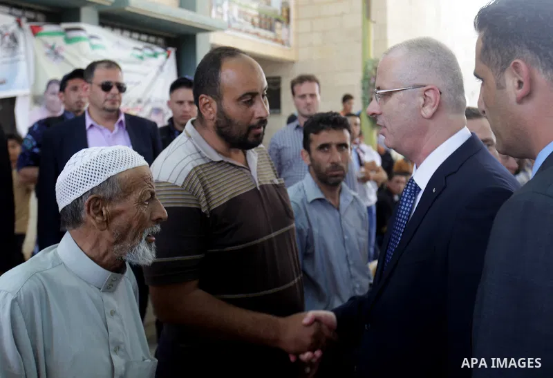 Palestinian Prime Minister Rami Hamdallah offers condolences to the Family of Palestinian Saad Dawabsha, the father of a Palestinian toddler killed last week when their home was firebombed by Jewish extremists, in Duma v...