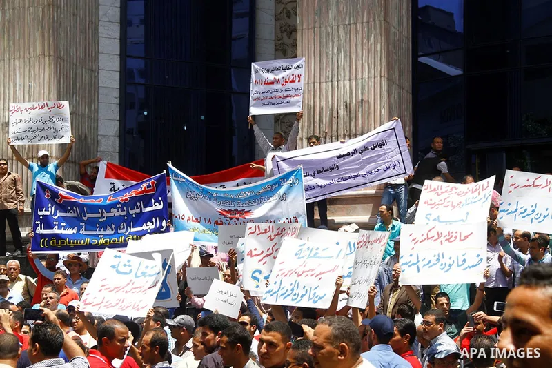 Staff and workers of Egypt's Ministry of Finance Tax Authority shout slogans against Finance Minister Hany Kadry Dimian and the government during a protest in front of the Syndicate of Journalists in Cairo, August 10, 20...