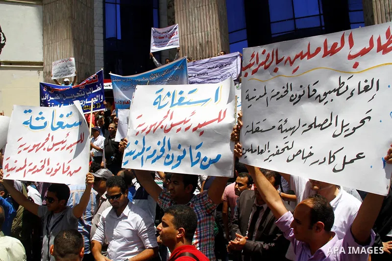 Staff and workers of Egypt's Ministry of Finance Tax Authority shout slogans against Finance Minister Hany Kadry Dimian and the government during a protest in front of the Syndicate of Journalists in Cairo, August 10, 20...