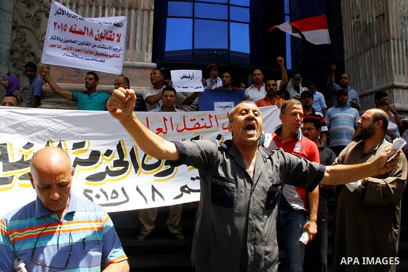 Staff and workers of Egypt's Ministry of Finance Tax Authority shout slogans against Finance Minister Hany Kadry Dimian and the government during a protest in front of the Syndicate of Journalists in Cairo, August 10, 20...