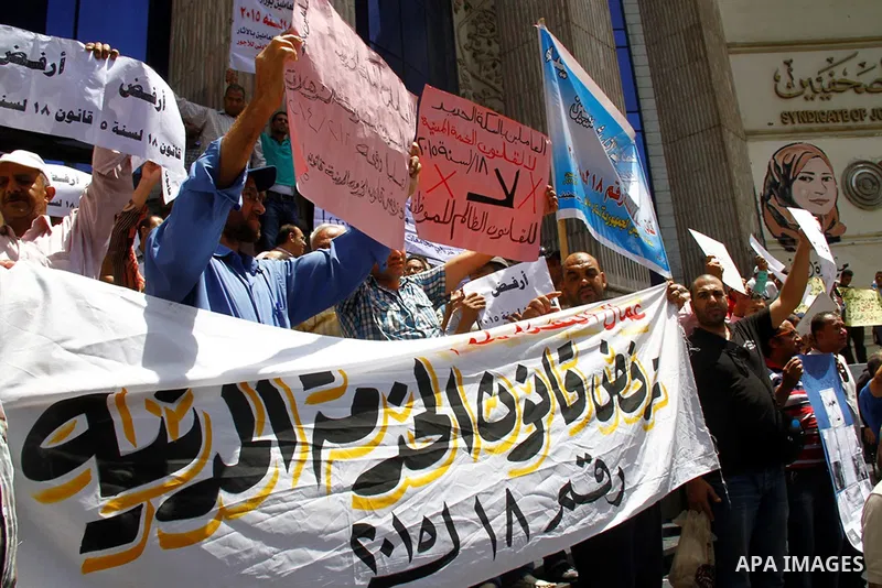 Staff and workers of Egypt's Ministry of Finance Tax Authority shout slogans against Finance Minister Hany Kadry Dimian and the government during a protest in front of the Syndicate of Journalists in Cairo, August 10, 20...