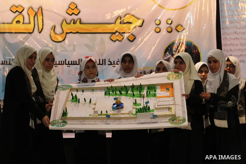 Palestinian girls take part in a graduation ceremony of a military-style camp organized by the Hamas movement, in Gaza city, on August 11, 2015. Photo by Mohammed Asad