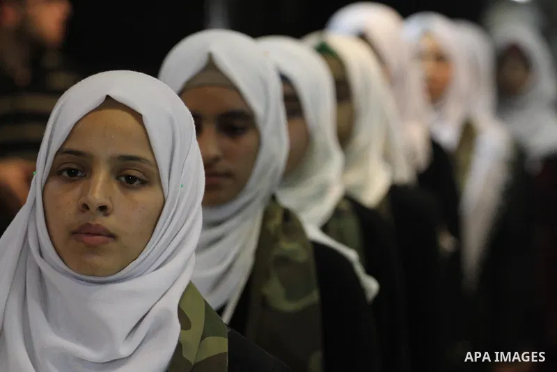 Palestinian girls take part in a graduation ceremony of a military-style camp organized by the Hamas movement, in Gaza city, on August 11, 2015. Photo by Mohammed Asad