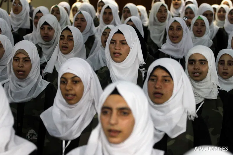 Palestinian girls take part in a graduation ceremony of a military-style camp organized by the Hamas movement, in Gaza city, on August 11, 2015. Photo by Mohammed Asad