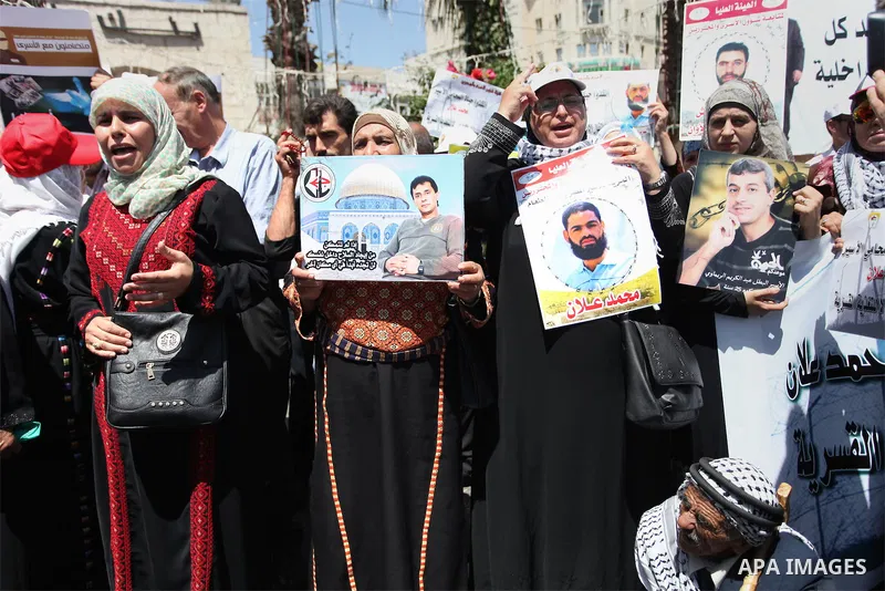 Protesters hold portraits of Palestinian prisoner in Israeli jails Mohammad Allan, during a protest in the West Bank city of Ramallah, on August 11, 2015. The Israeli military prosecutor intends to request court permissi...