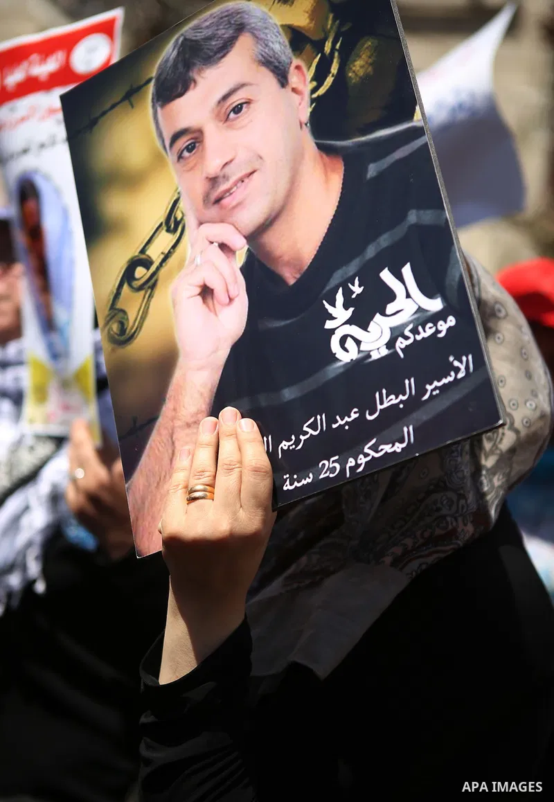Protesters hold portraits of Palestinian prisoner in Israeli jails Mohammad Allan, during a protest in the West Bank city of Ramallah, on August 11, 2015. The Israeli military prosecutor intends to request court permissi...