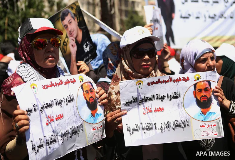 Protesters hold portraits of Palestinian prisoner in Israeli jails Mohammad Allan, during a protest in the West Bank city of Ramallah, on August 11, 2015. The Israeli military prosecutor intends to request court permissi...