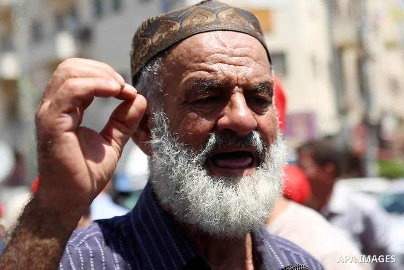 Protesters hold portraits of Palestinian prisoner in Israeli jails Mohammad Allan, during a protest in the West Bank city of Ramallah, on August 11, 2015. The Israeli military prosecutor intends to request court permissi...