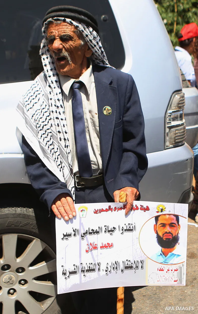 Protesters hold portraits of Palestinian prisoner in Israeli jails Mohammad Allan, during a protest in the West Bank city of Ramallah, on August 11, 2015. The Israeli military prosecutor intends to request court permissi...