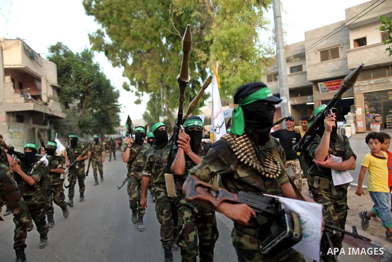 Members of Ezzedeen al-Qassam brigades, the armed wing of Hamas movement, take part in an anti-Israel parade in Beit Hanoun, in the northern Gaza Strip, on August 11, 2015. Photo by Ashraf Amra